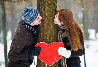 man and woman holding heart